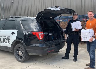 Brent Looby donates cases of hand sanitizer to the University of Texas police department.