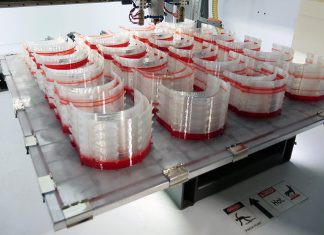 3D printing 150 face shield halos at a time on Titan's Atlas 3D printer with pellet extrusion.