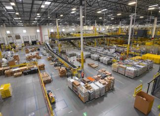 An Amazon warehouse where people and robots work together, in a safe environment.