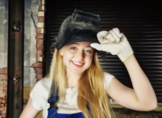 female welder welding