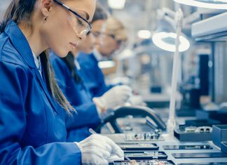 High tech factory workers assembling technology products. Credit: gorodenkoff iStockphoto LP