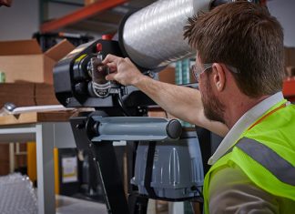 Sealed Air employees working in protective packaging tech services (photo taken before COVID).