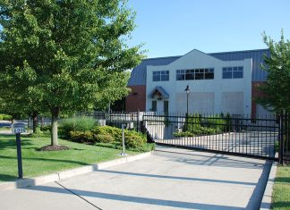 A cable landing station in a mixed-use neighborhood as seen from the street, featuring controlled access.