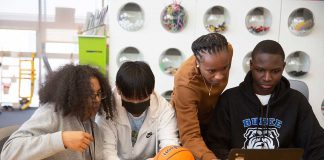 Students from Burke High School in Boston explore Scratch coding with an MIT Research Assistant at a Waters Student Academy event.