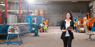 Woman reviewing manufacturing schedules on a production floor