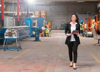Woman reviewing manufacturing schedules on a production floor