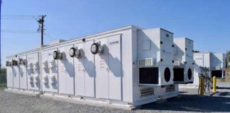 Several AiON-ESS Energy Series containerized energy storage units from LS Energy Solutions are seen at a Strata Clean Energy site