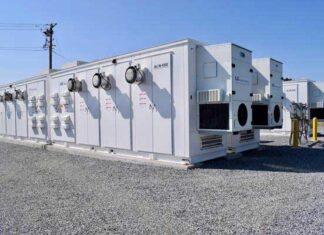 Several AiON-ESS Energy Series containerized energy storage units from LS Energy Solutions are seen at a Strata Clean Energy site